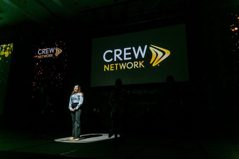 CREW Network individual female on stage speaking