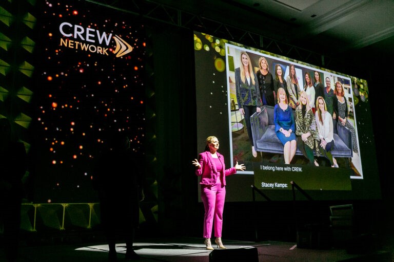 CREW Network individual female on stage speaking