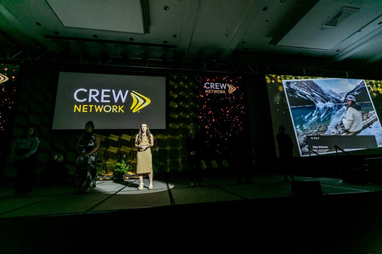 CREW Network a female discussing slides on stage